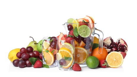 Photo of Jug, glasses and different fruits on white background
