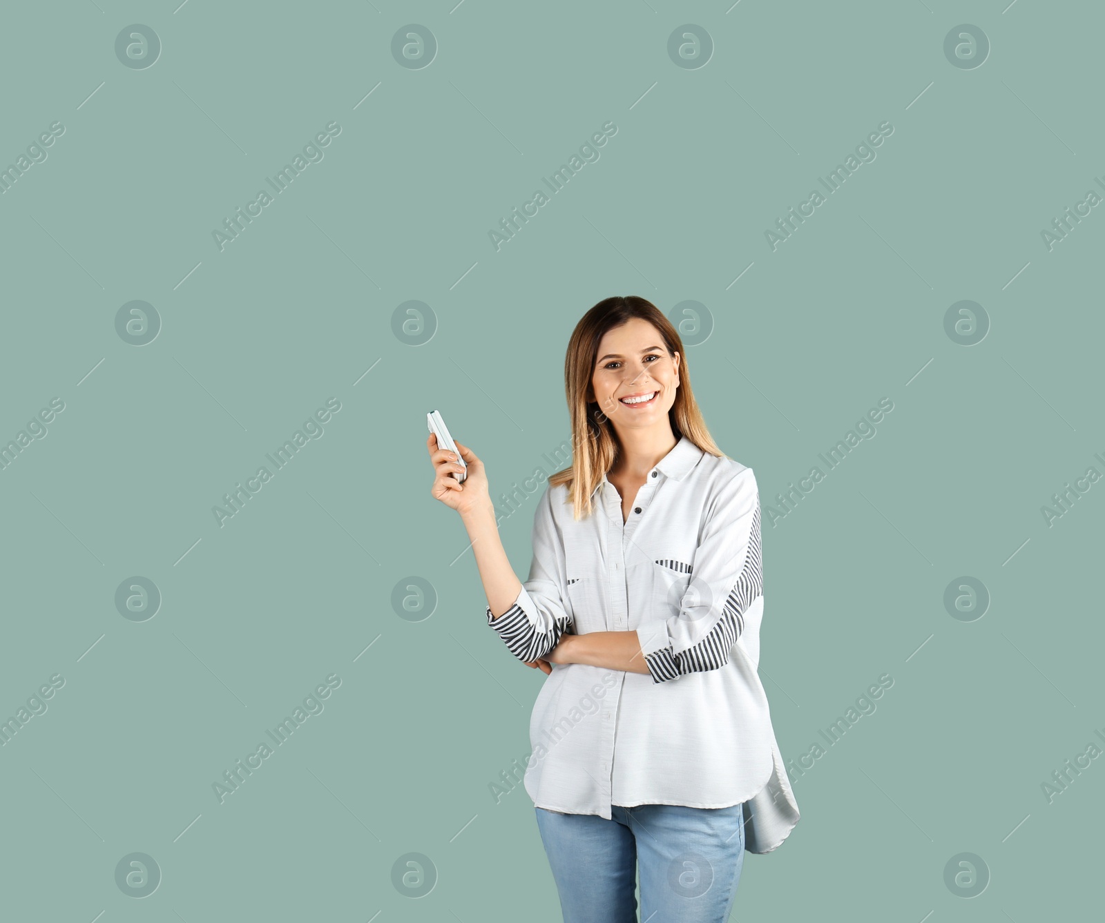 Photo of Woman with air conditioner remote on color background