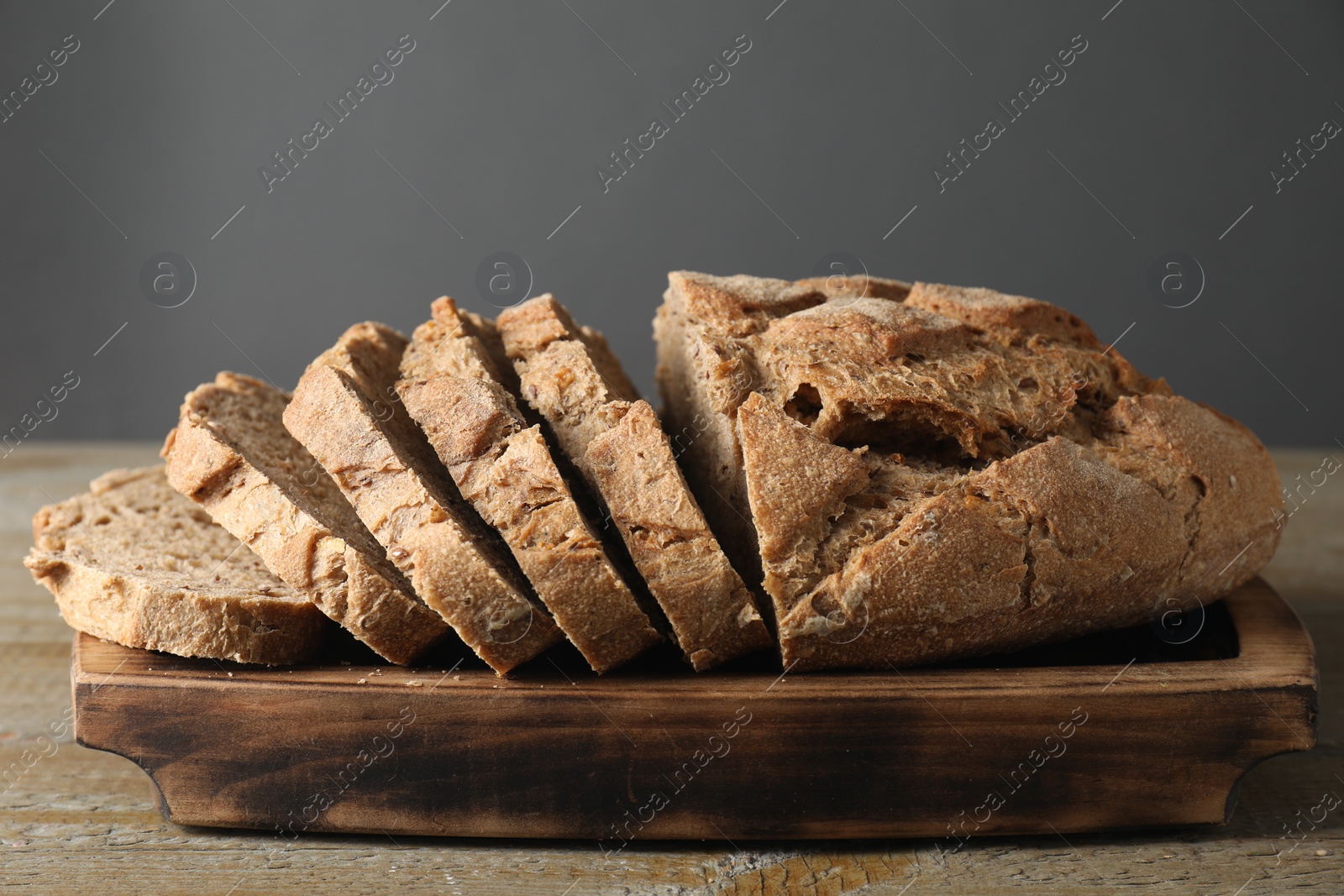 Photo of Freshly baked cut sourdough bread on wooden table