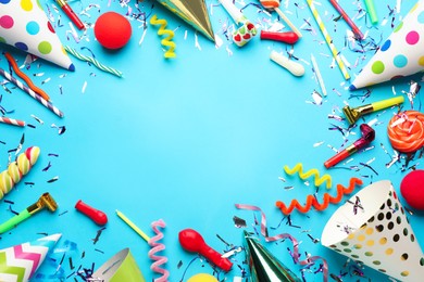 Photo of Beautiful flat lay composition with festive items on light blue background, space for text. Surprise party concept