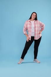 Photo of Beautiful overweight woman with charming smile on turquoise background