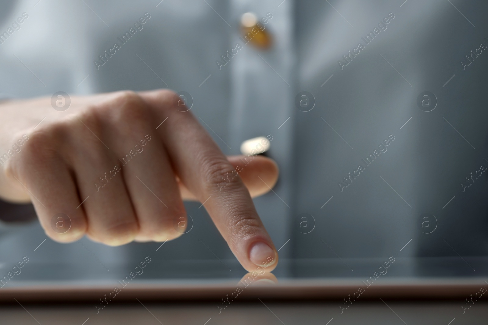 Photo of Closeup view of woman using modern tablet at table