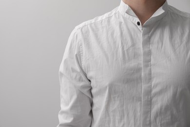 Photo of Man wearing rumpled shirt on white background, closeup