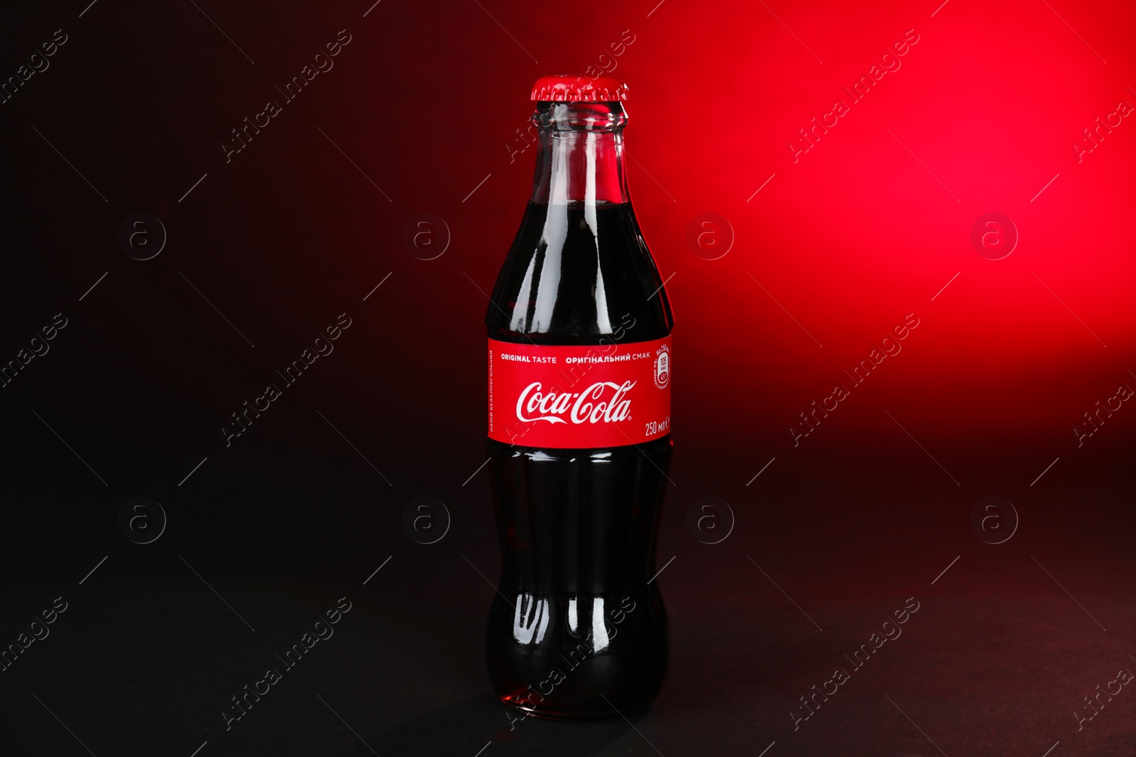 Photo of MYKOLAIV, UKRAINE - NOVEMBER 14, 2018: Bottle of Coca-Cola on color background