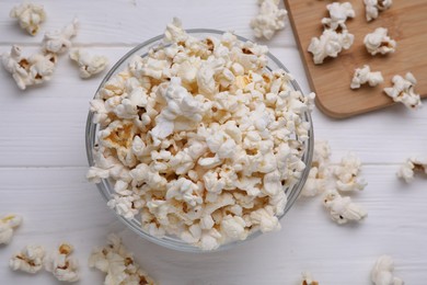 Photo of Tasty popcorn on white wooden table, flat lay