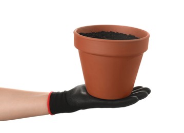 Woman holding terracotta flower pot filled with soil on white background, closeup
