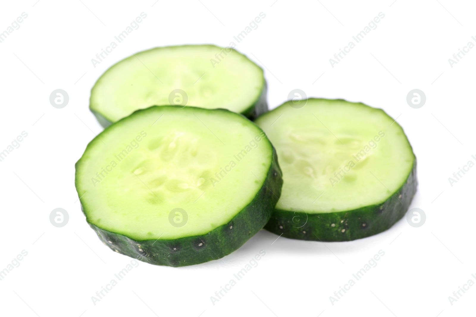 Photo of Slices of fresh cucumber on white background