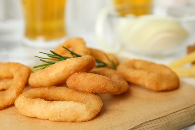 Photo of Fried onion rings served on table, closeup