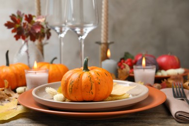 Beautiful autumn place setting and decor on wooden table