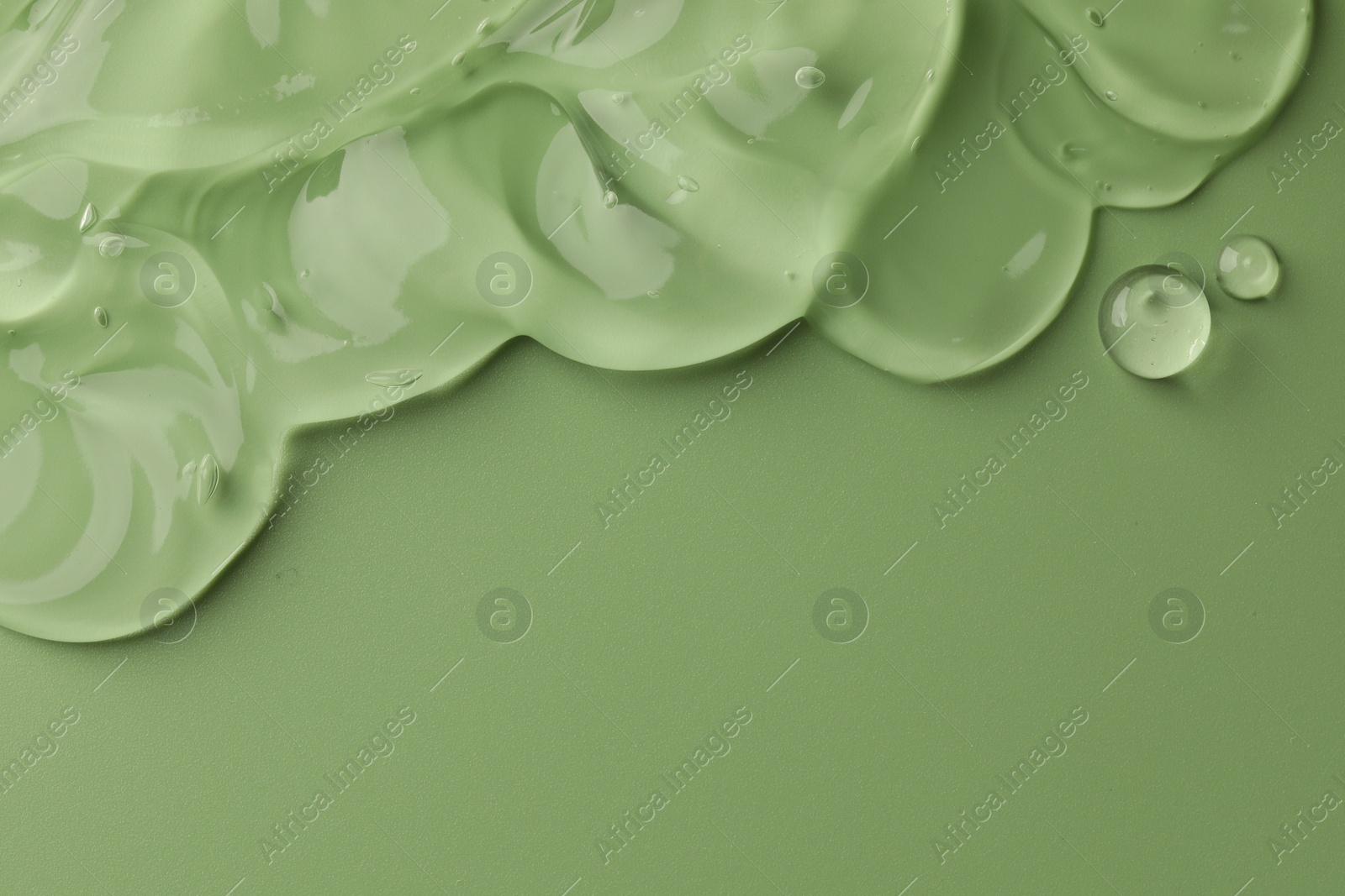 Photo of Clear cosmetic gel on light green background, top view. Space for text