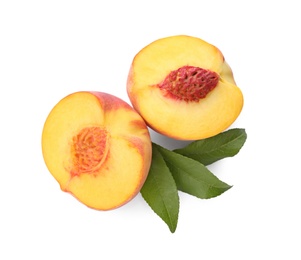 Photo of Halves of ripe peach with leaves on white background, top view