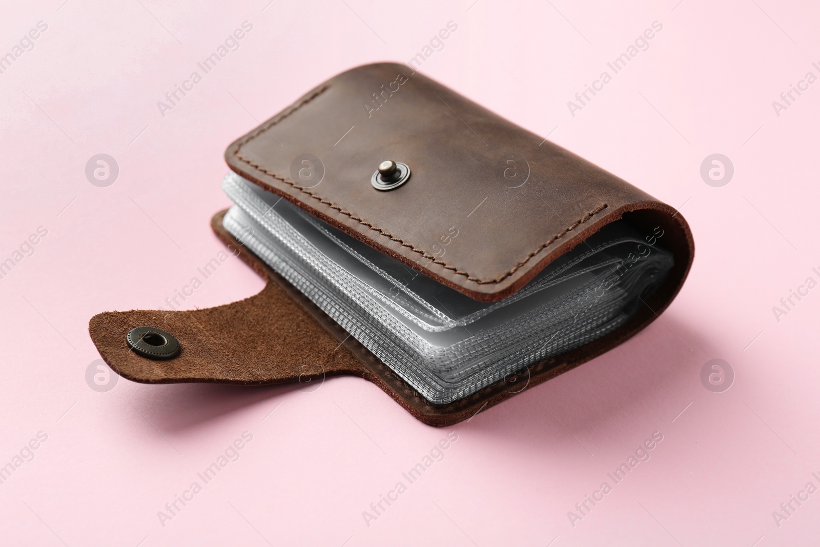 Photo of New leather card holder on pink background