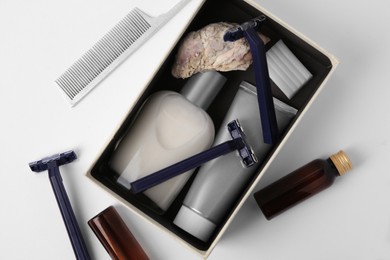 Different men's shaving accessories and box on white background, flat lay