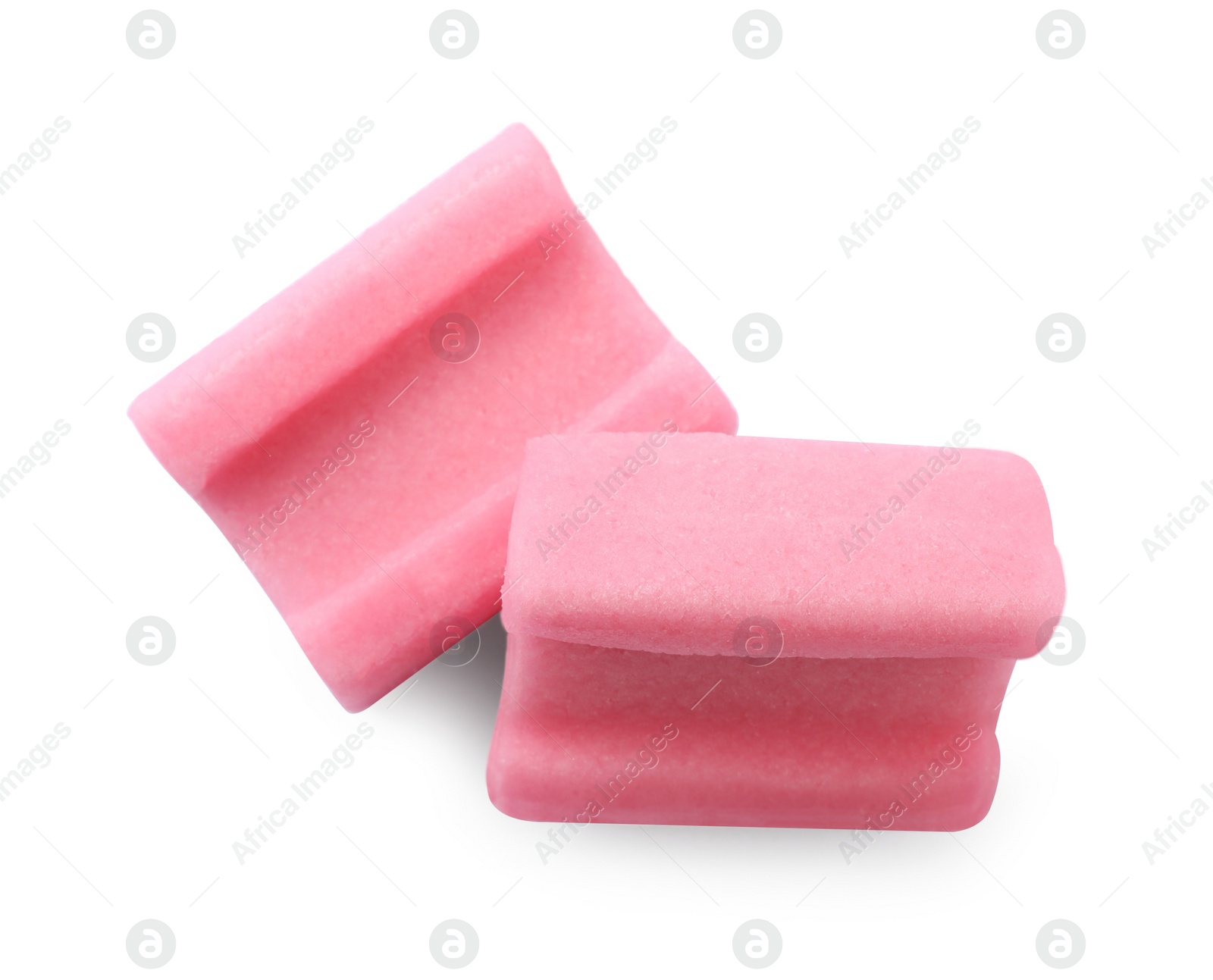 Photo of Tasty pink chewing gums on white background, top view