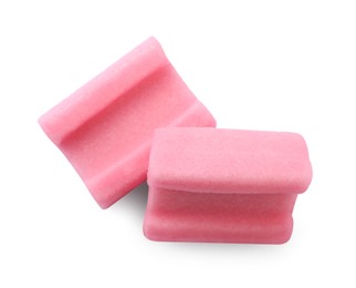 Photo of Tasty pink chewing gums on white background, top view