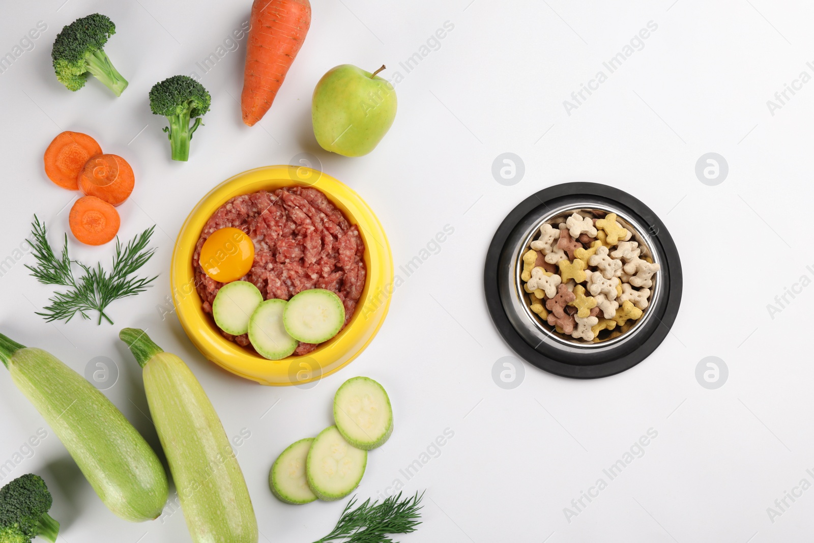 Photo of Pet food and natural ingredients on white background, top view