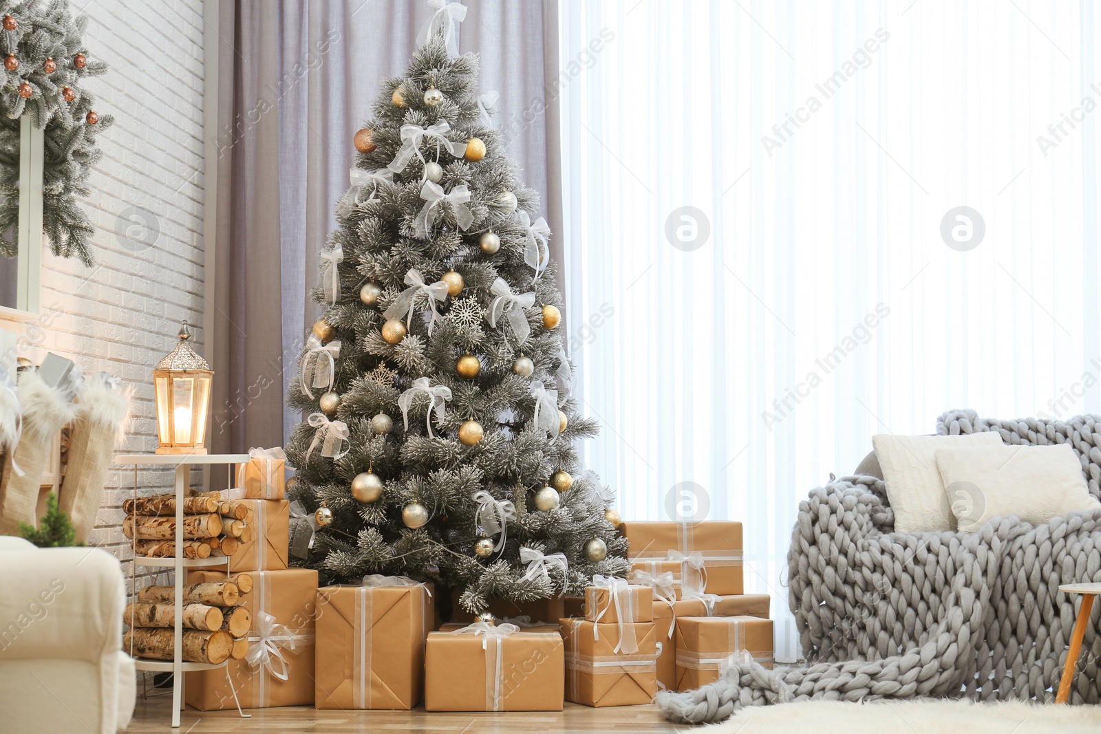 Photo of Room interior with decorated Christmas tree and gifts near window