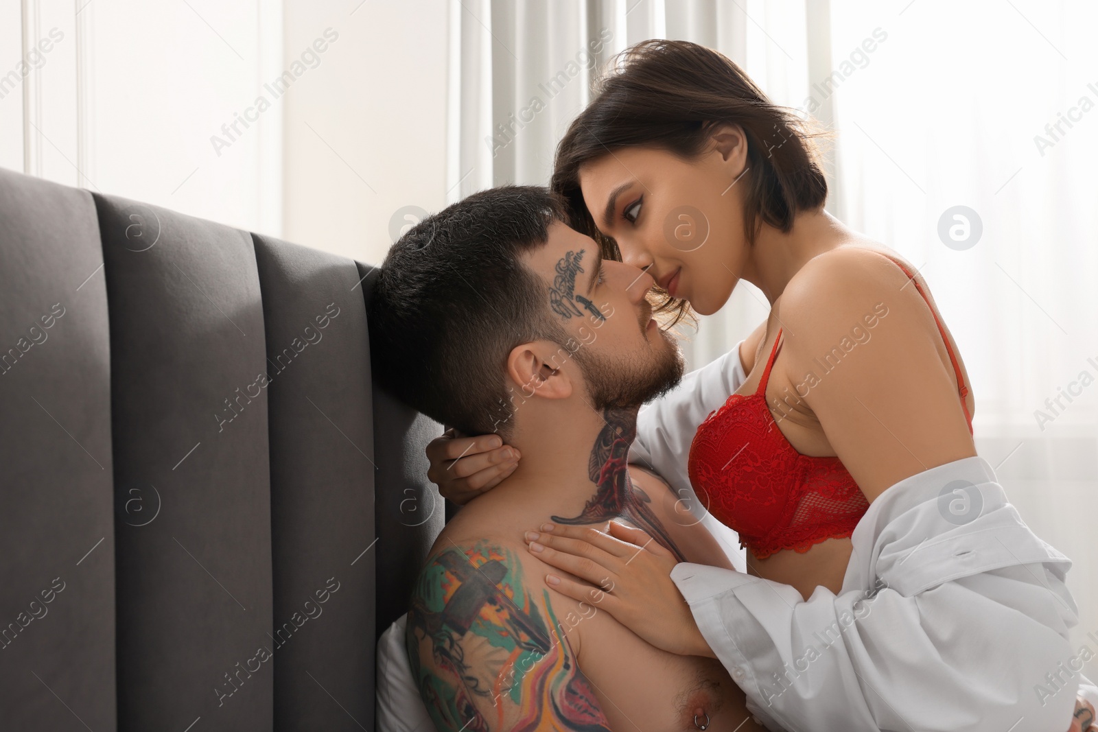 Photo of Passionate couple having sex on bed at home