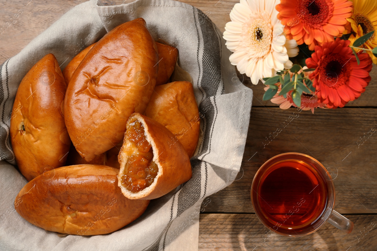 Photo of Flat lay composition with delicious baked patties on wooden table