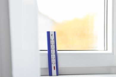 Photo of Weather thermometer on window sill indoors. Space for text