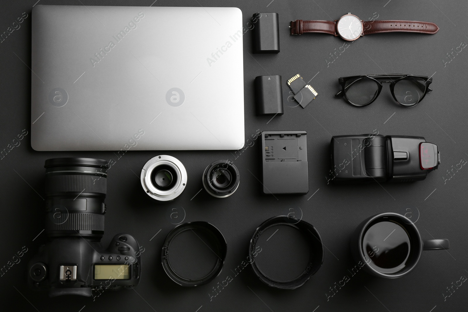 Photo of Flat lay composition with professional photographer equipment on dark background