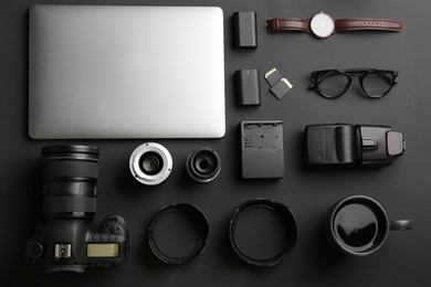 Photo of Flat lay composition with professional photographer equipment on dark background