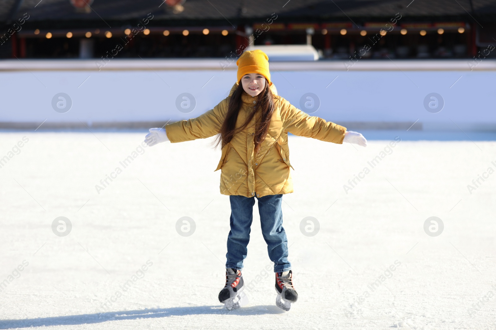 Image of Cute little girl at outdoor ice skating rink