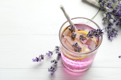 Photo of Fresh delicious lemonade with lavender on white wooden table. Space for text