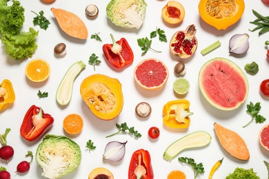 Photo of Fresh organic fruits and vegetables on white background, flat lay