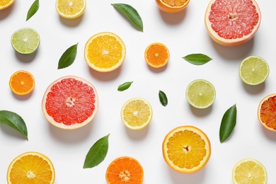 Flat lay composition with different citrus fruits on white background