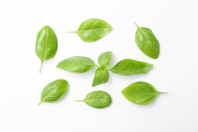 Photo of Fresh green basil leaves on white background, top view