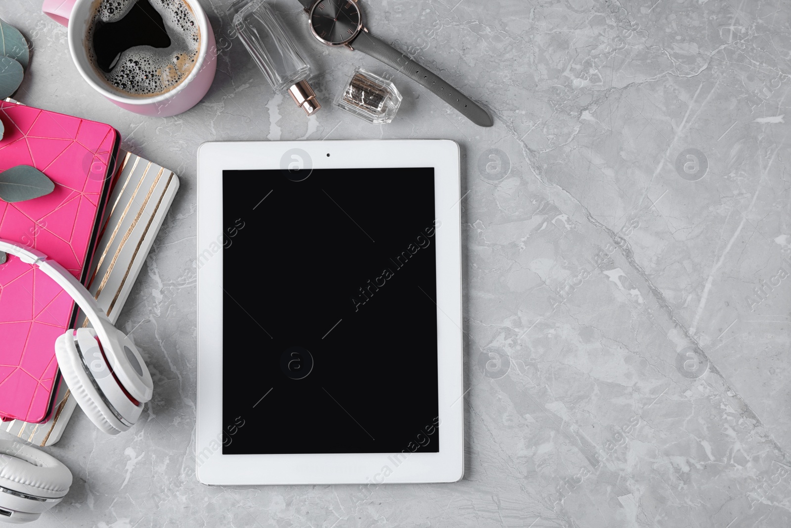 Photo of Flat lay composition with tablet on grey background, space for text. Blogger's workplace