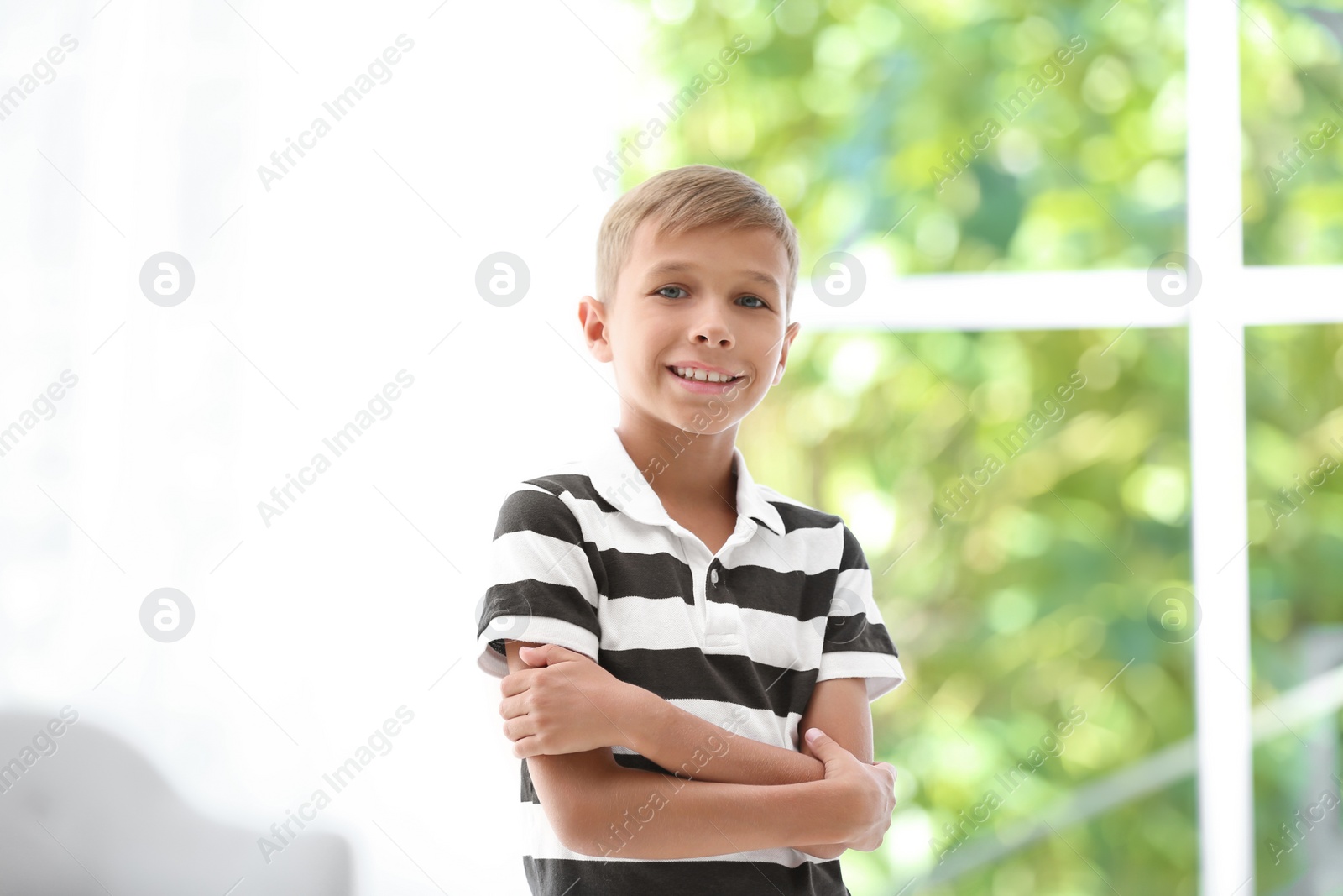 Photo of Adorable little boy in casual clothes on blurred background