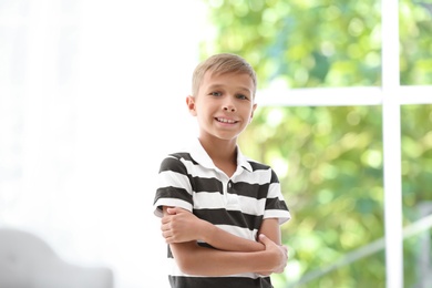 Adorable little boy in casual clothes on blurred background