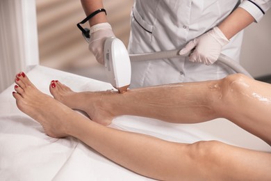 Woman undergoing laser epilation procedure in beauty salon, closeup