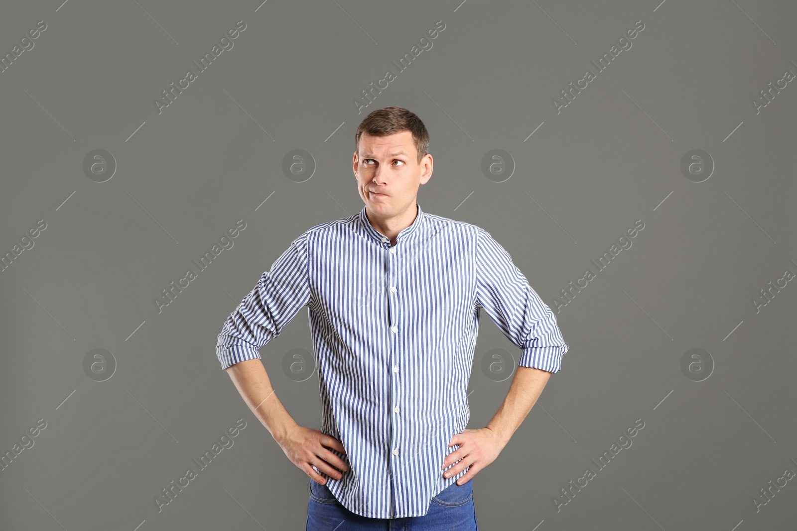 Photo of Emotional man in casual outfit on grey background