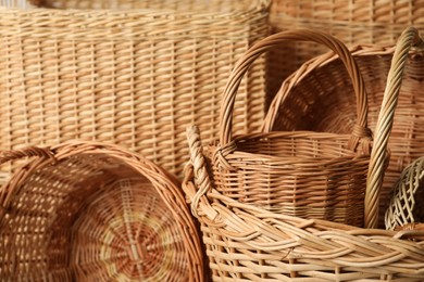 Photo of Many different wicker baskets made of natural material as background