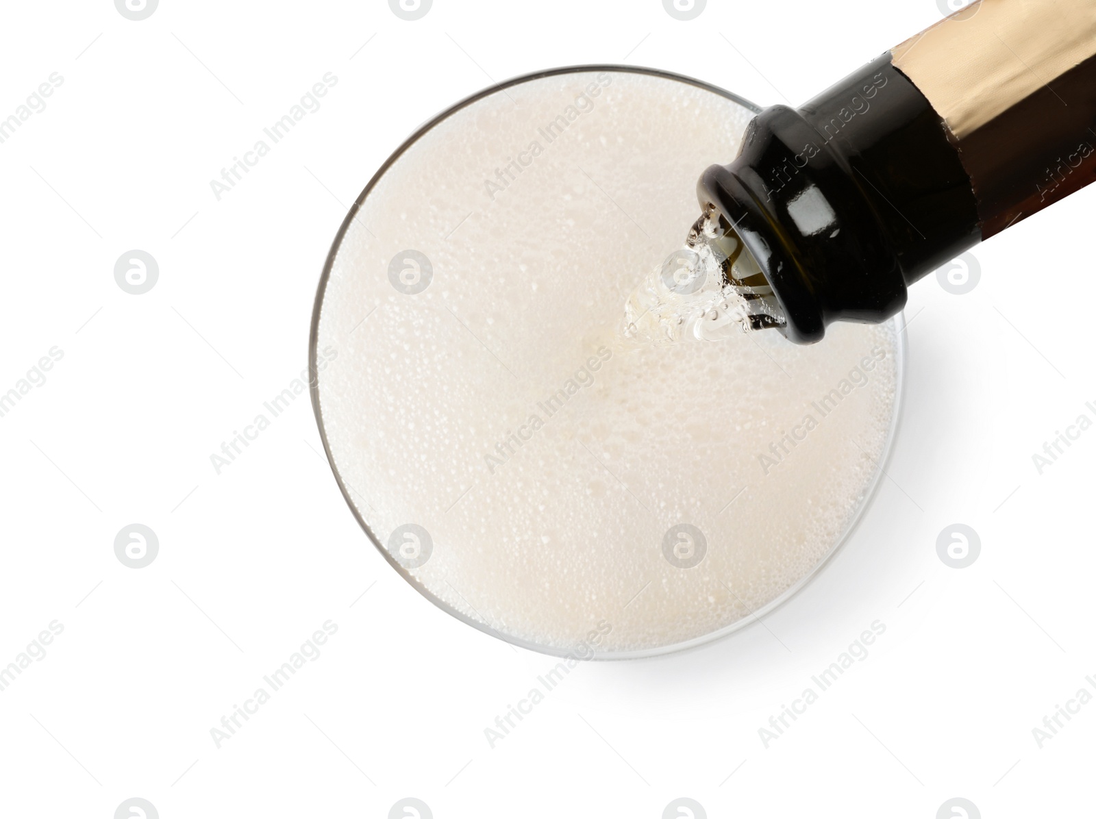 Photo of Champagne pouring from bottle into glass isolated on white, top view