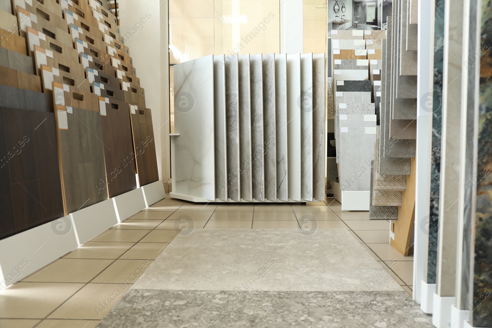 Photo of Assortment of tiles in store. Many different samples indoors