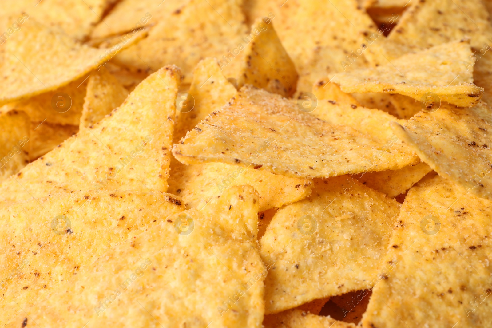 Photo of Tasty Mexican nachos chips as background, closeup