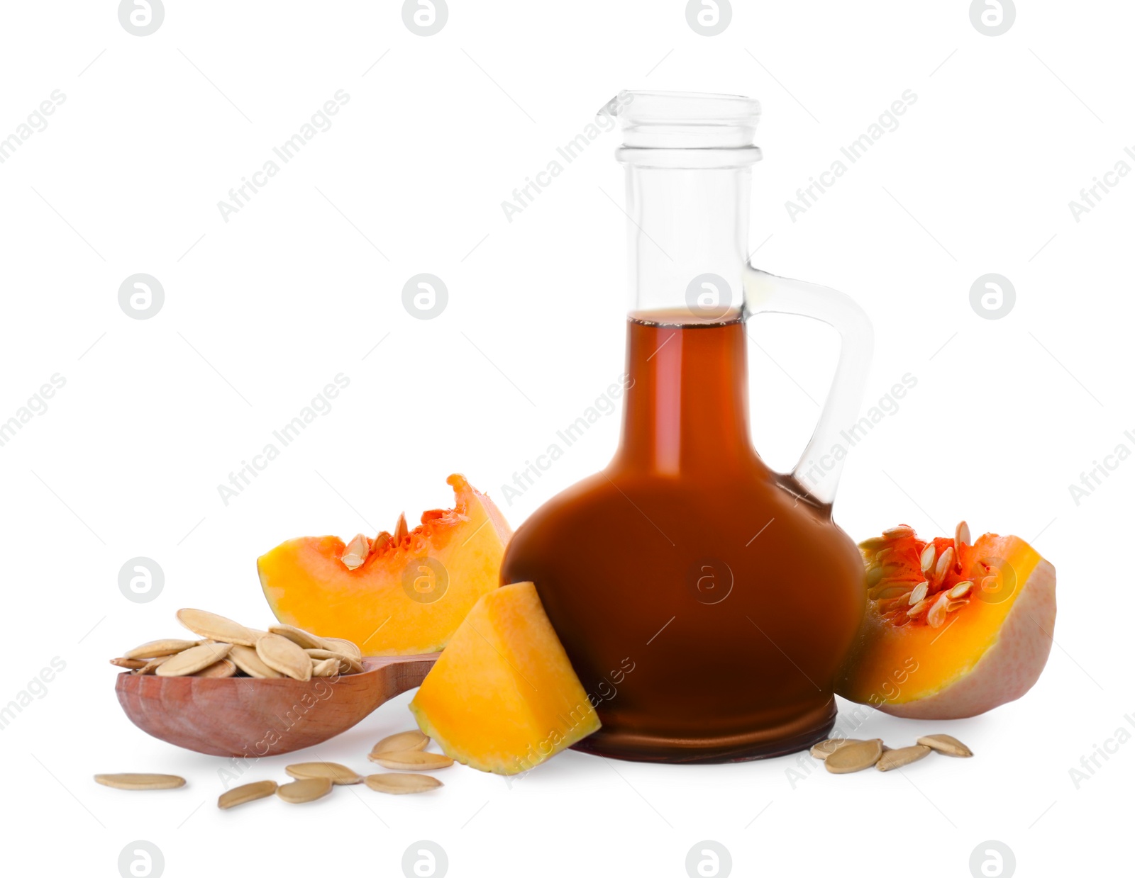 Photo of Fresh pumpkin seed oil in glass jug isolated on white
