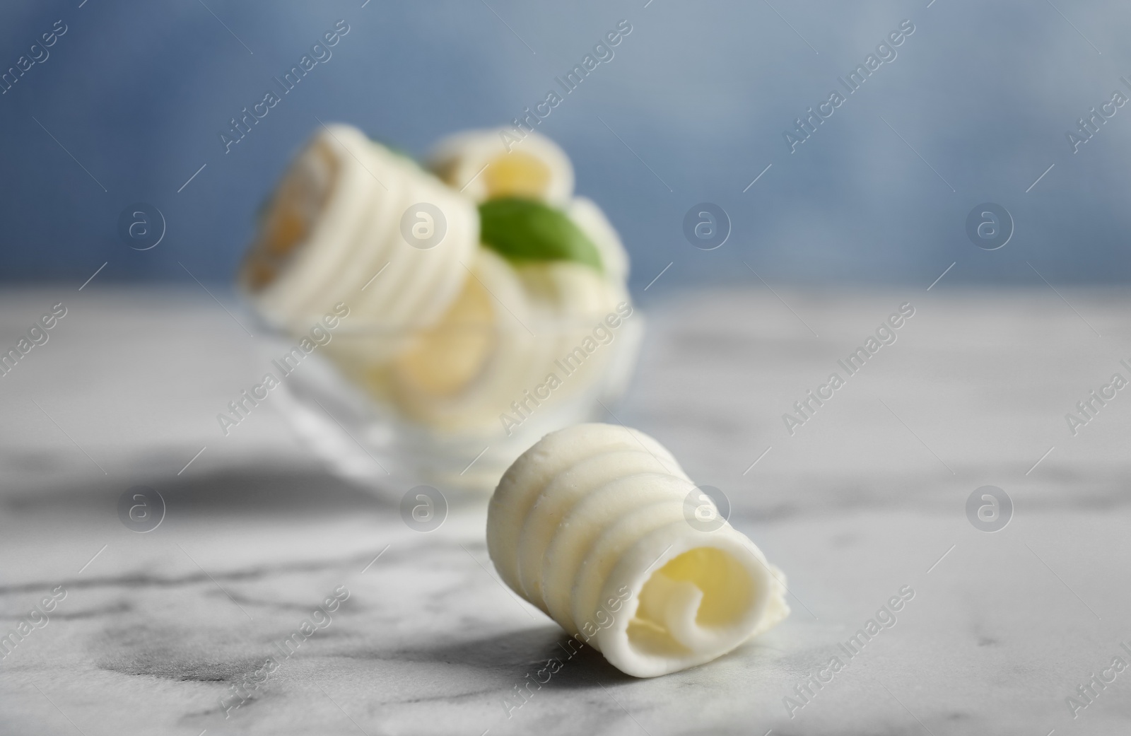 Photo of Tasty butter curl on table, closeup