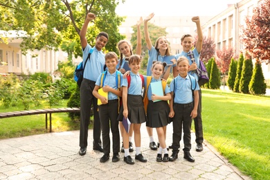 Photo of Group of children in stylish school uniform outdoors