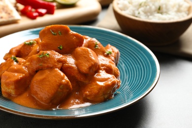 Photo of Plate with butter chicken on table, closeup. Traditional indian Murgh Makhani