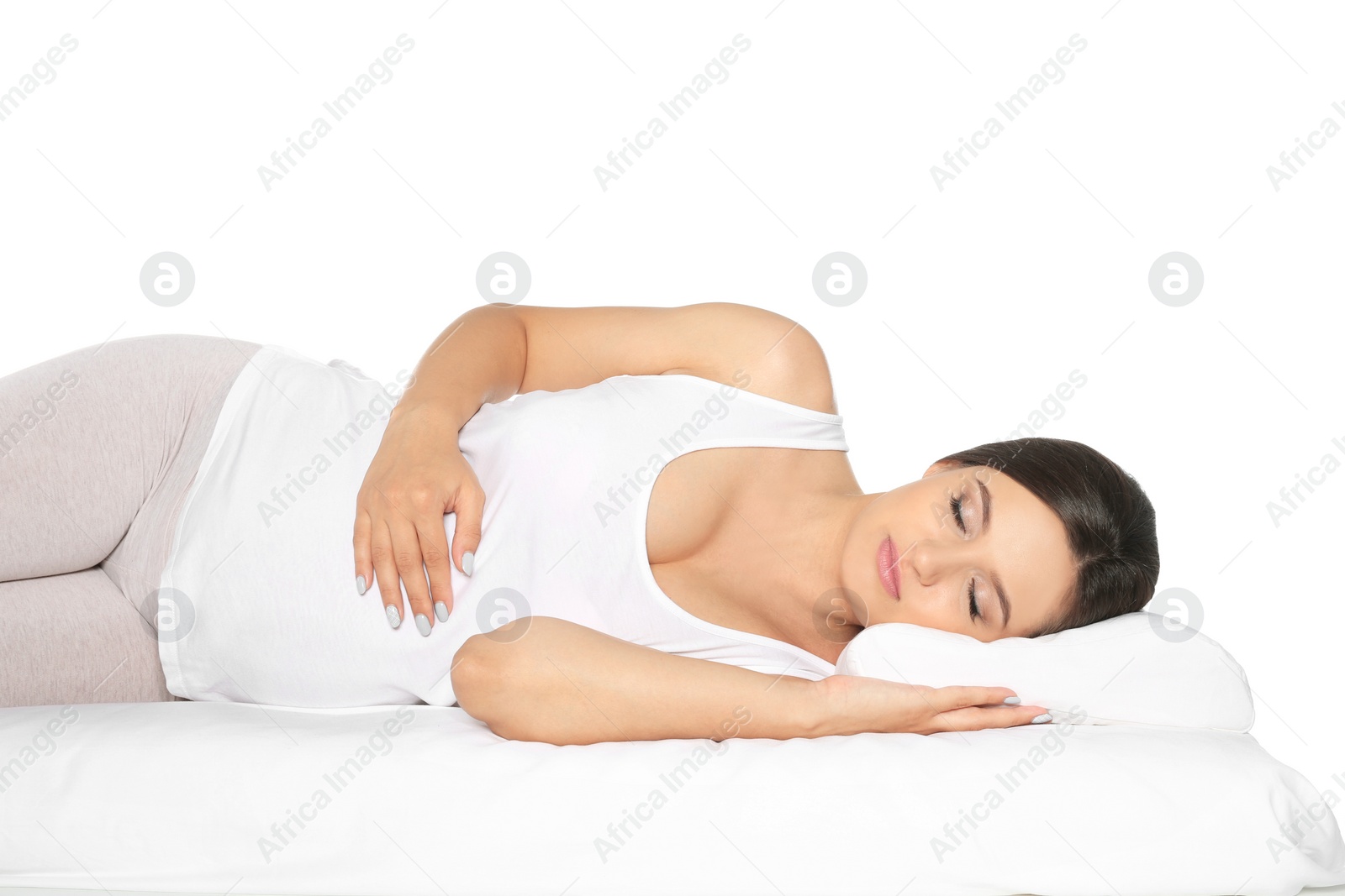 Photo of Beautiful pregnant woman sleeping with orthopedic pillow on bed against white background