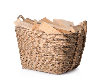 Photo of Wicker basket with cut firewood isolated on white