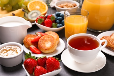 Photo of Buffet service. Tasty breakfast served on grey table