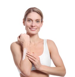 Woman applying body cream onto her arm against white background