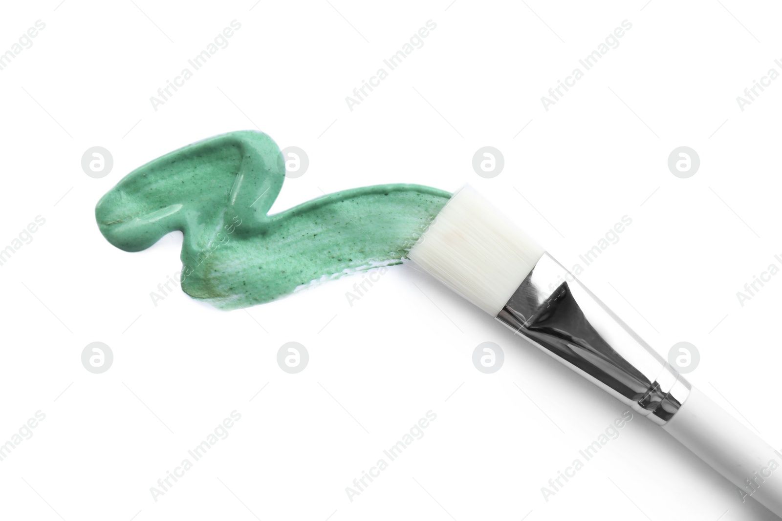 Photo of Spirulina facial mask smeared with makeup brush on white background