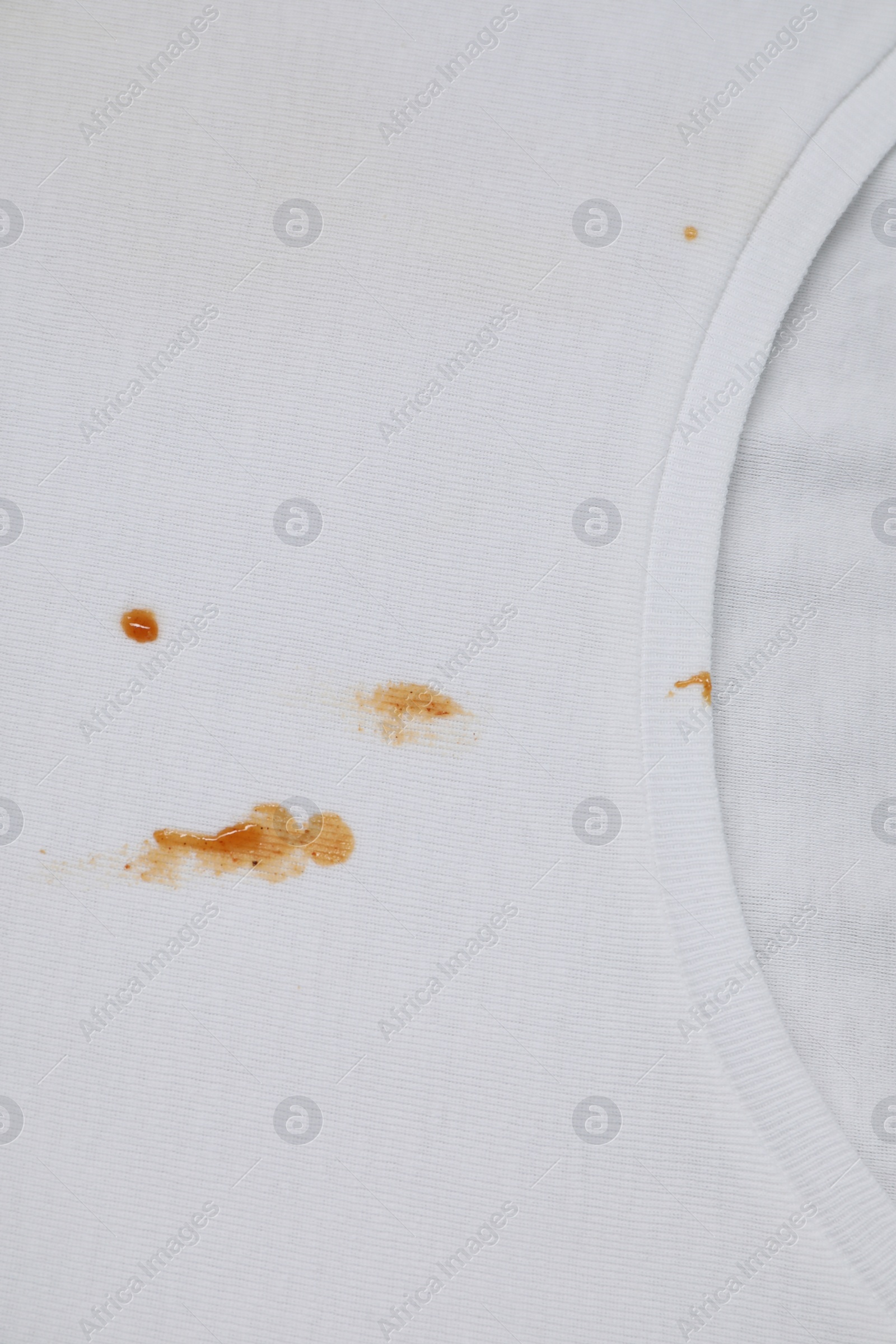 Photo of Stains of sauce on white t-shirt, top view